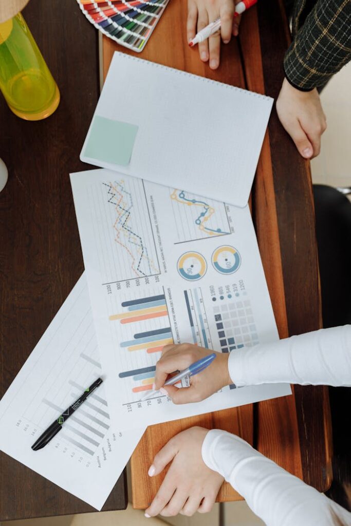 Mastering the First Impression: Your intriguing post title goes here Top view of business team analyzing charts and data on paper for strategic planning.