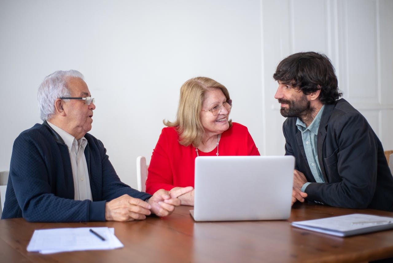 The Art of Drawing Readers In: Your attractive post title goes here Elderly couple having a consultation with a professional advisor in a bright indoor setting.